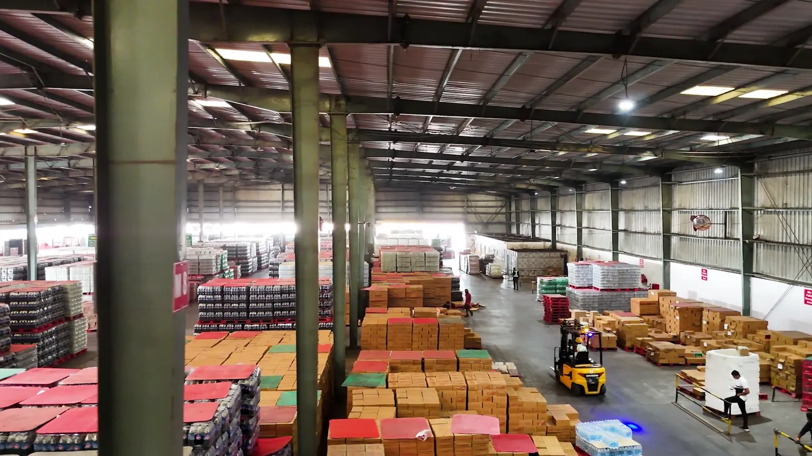 Forklift operations among racked FMCG stock inside Patna warehouse